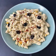 Creamy fusilli topped with black olives and chilli flakes